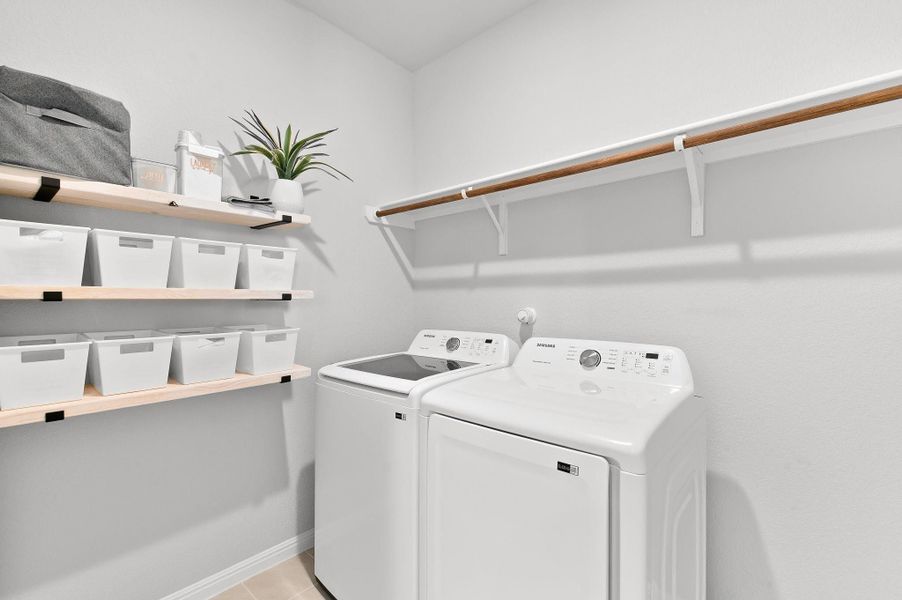 oversized laundry room with built in shelves and ample storage and room for hang up clothing oversized laundry room with built in shelves and ample storage and room for hang up clothing