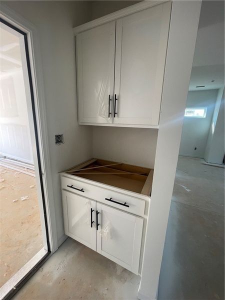 This functional kitchen features white cabinetry a
