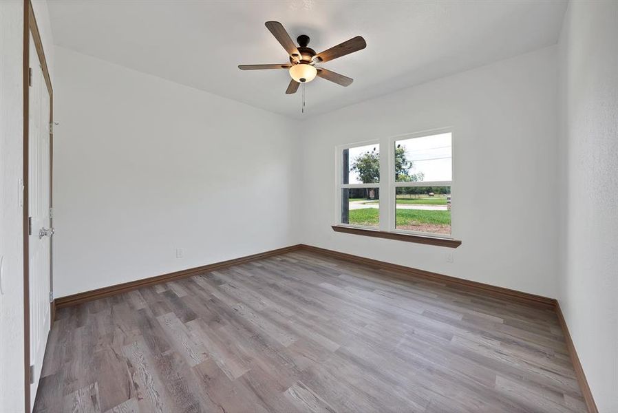 Unfurnished room featuring wood finished floors and a ceiling fan