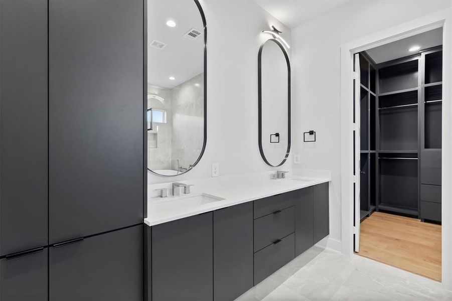 Bathroom with hardwood / wood-style floors, vanity, and walk in shower