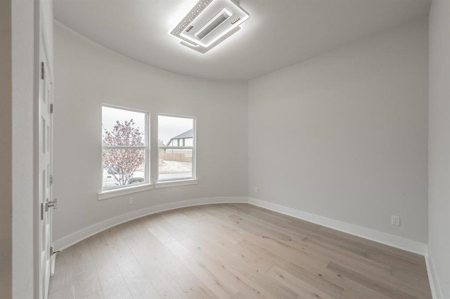 Spare room featuring light wood finished floors and cooling unit