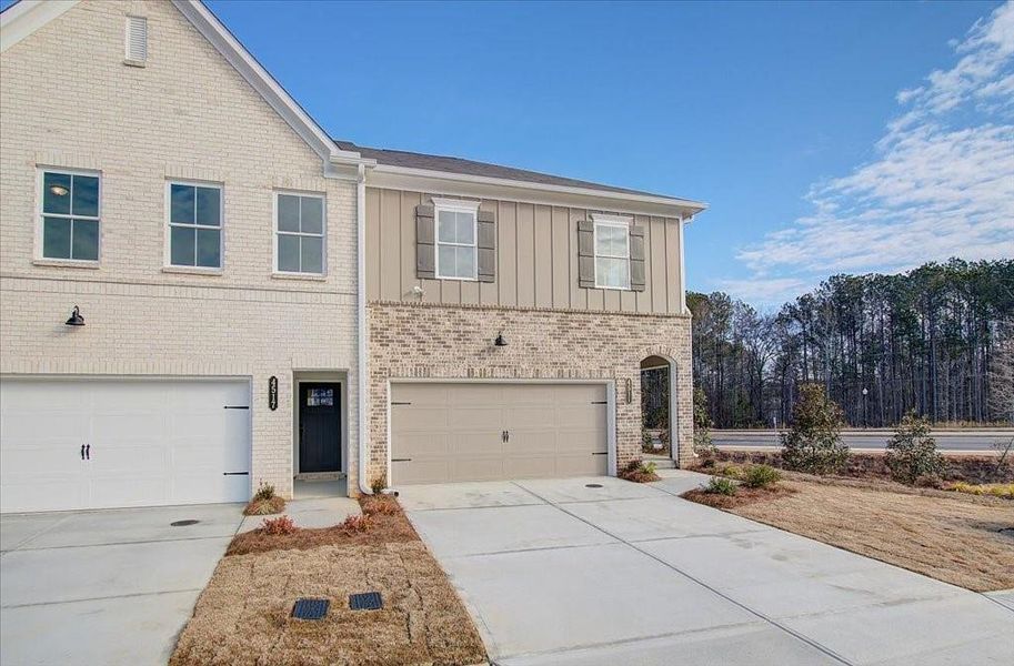 Front exterior of a new home in Wildwood Place, Powder Springs, GA, highlighting curb appeal (Image 21).