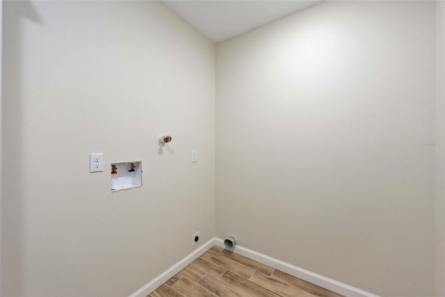 Convenient indoor utility room with space for a washer and dryer, plus extra storage.