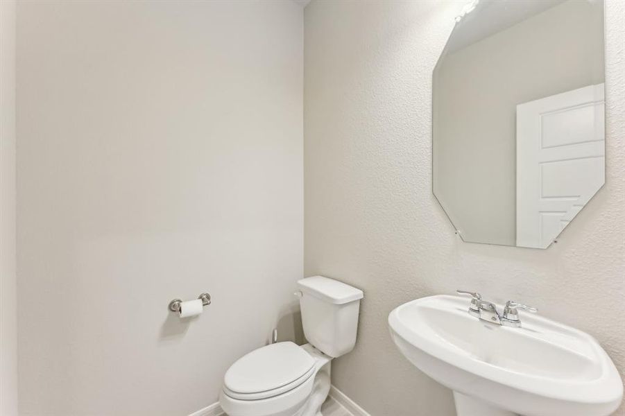 Enjoy the convenience of a well-placed powder room, perfect for guests.