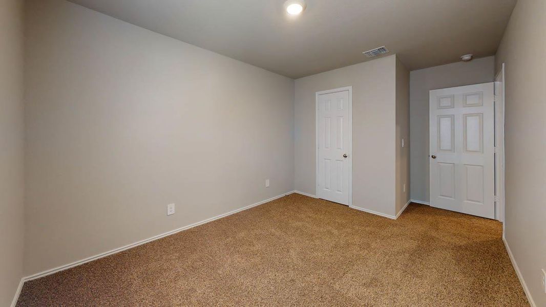 Unfurnished bedroom with carpet flooring and baseboards