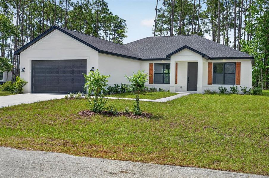 Front exterior of a new home in , Palm Coast, FL, highlighting curb appeal (Image 21). Front exterior of a new home in , Palm Coast, FL, highlighting curb appeal (Image 21).