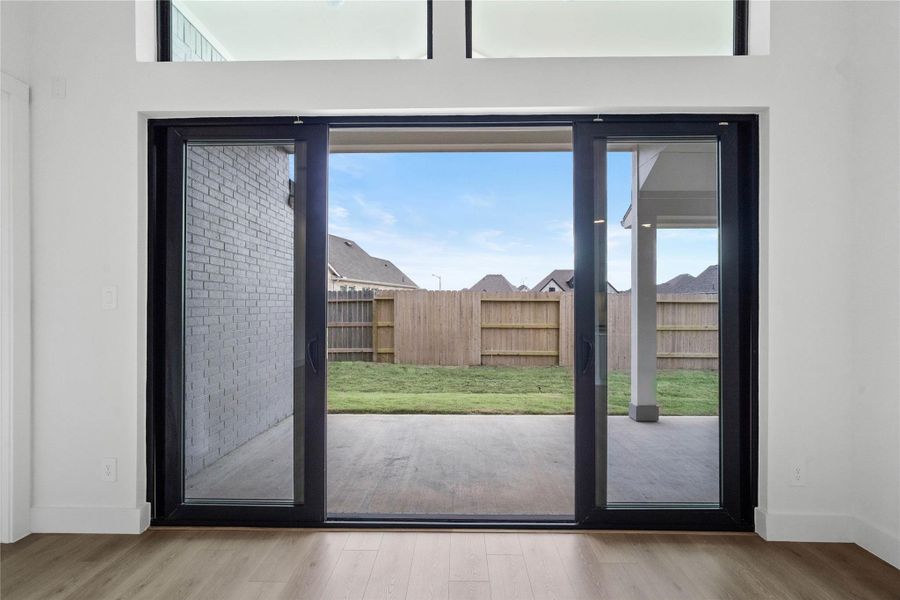 This four-panel multi-slide glass door serves as a stunning architectural focal point, featuring two fixed end panels and two center panels that glide open to create an expansive, unobstructed transition to the patio. This four-panel multi-slide glass door serves as a stunning architectural focal point, featuring two fixed end panels and two center panels that glide open to create an expansive, unobstructed transition to the patio.