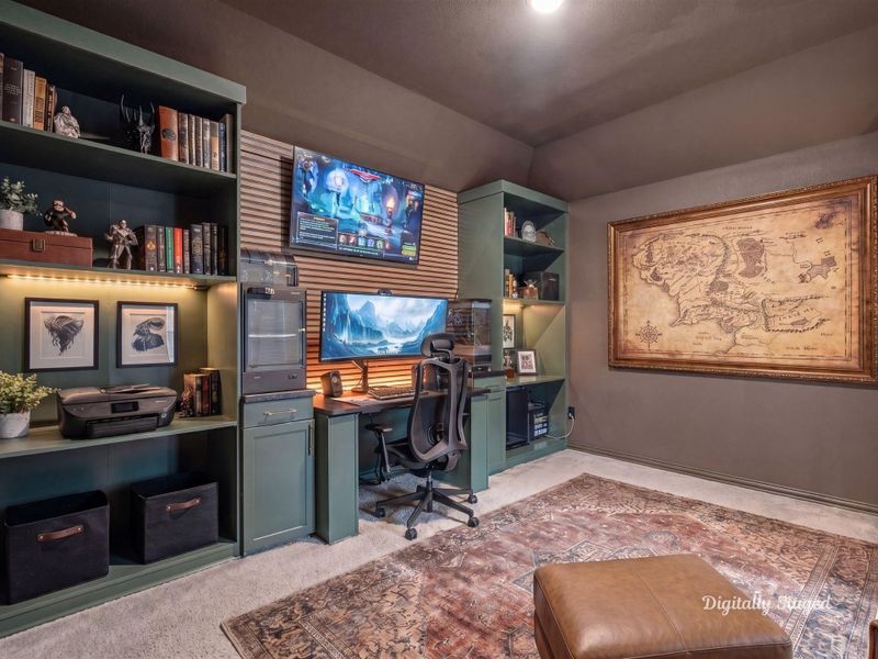 Flexible room showcasing custom built-in shelving and a desk with ample cabinet storage. Carpeted and quietly tucked away, it works beautifully as a home office, study, or hobby room. This photo has been digitally staged to illustrate the possibilities of the home's aesthetic and potential design. Some furnishings and décor shown are for visual inspiration.