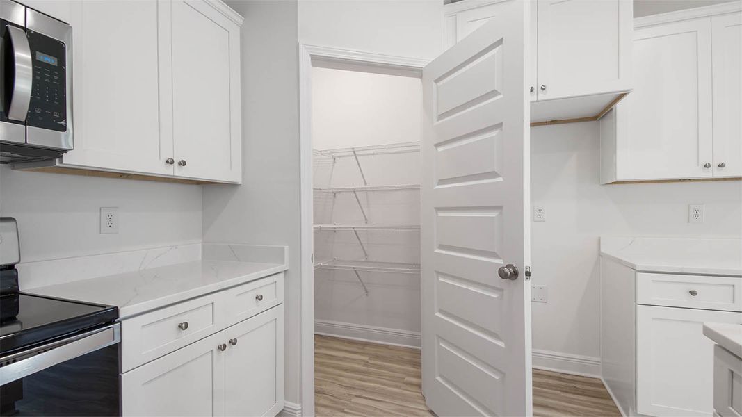 Representative furnished interior of a home built from the Kennedy by D.R. Horton in Bayside at Ward Creek, Panama City Beach (Image 7).