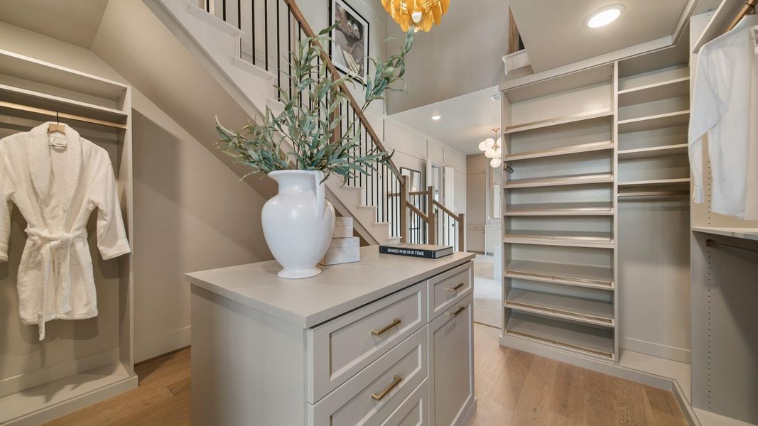 Representative photo of the main closet with a staircase that leads you up to tons of additional storage.
