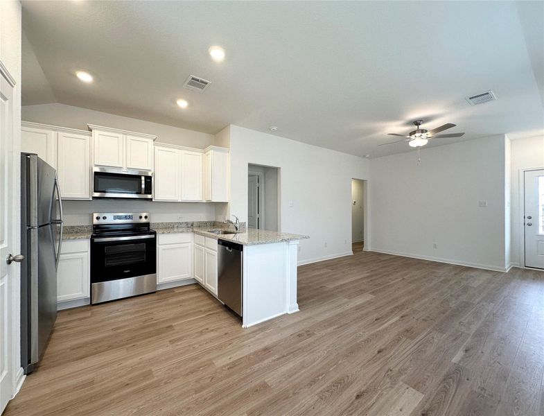 Kitchen includes granite countertops, luxury vinyl plank flooring, 36” upper cabinets with crown molding, a full suite of stainless-steel Whirlpool appliances – including refrigerator with ice maker, recessed lighting, and a large single basin sink. Kitchen includes granite countertops, luxury vinyl plank flooring, 36” upper cabinets with crown molding, a full suite of stainless-steel Whirlpool appliances – including refrigerator with ice maker, recessed lighting, and a large single basin sink.