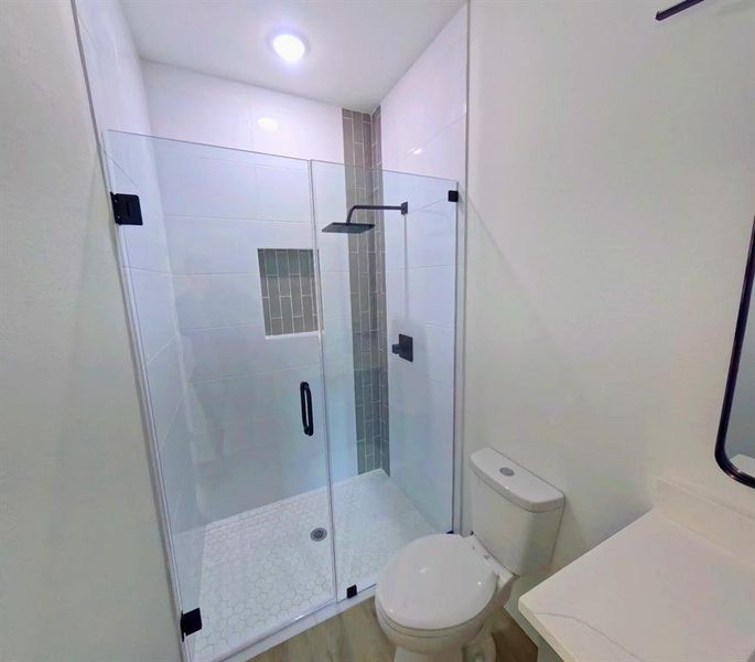 Bathroom featuring vanity and a shower stall Bathroom featuring vanity and a shower stall