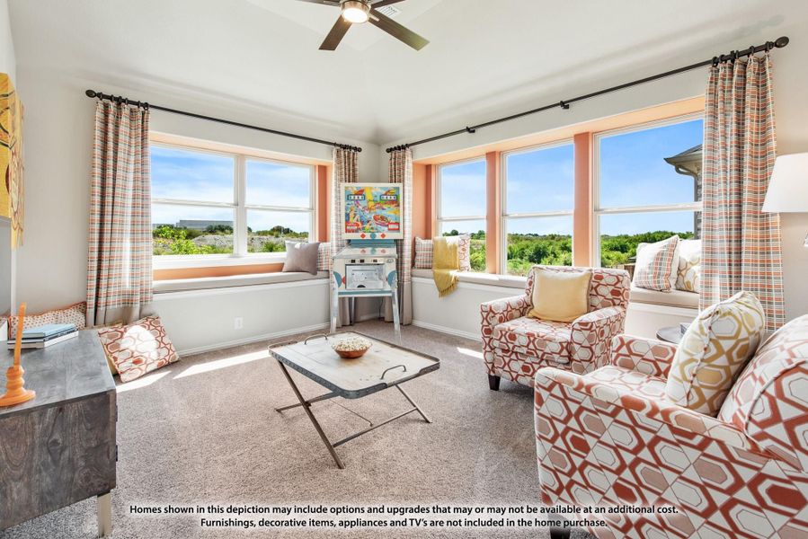 Bright sitting room with window seats, patterned armchairs, ceiling fan, and large windows overlooking greenery Bright sitting room with window seats, patterned armchairs, ceiling fan, and large windows overlooking greenery