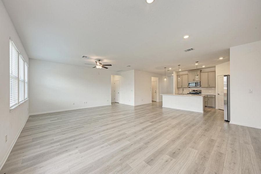An open concept living area transitions fluidly into a modern kitchen, creating an inviting entertainment space.