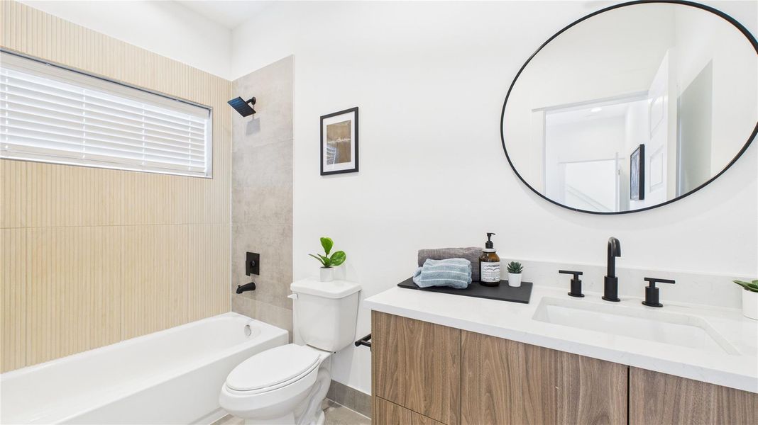 This first-floor secondary bedroom offers a private and convenient layout, featuring a spacious closet, a full ensuite bathroom, and direct access to the backyard ideal for guests or flexible everyday living.