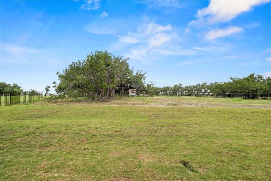 A verdant, open lot awaits your dream home, bordered by mature trees and secure fencing. A verdant, open lot awaits your dream home, bordered by mature trees and secure fencing.