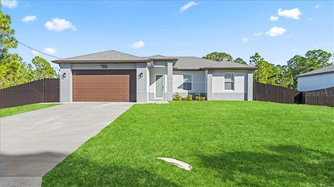 Front exterior of a new home in , Lehigh Acres, FL, highlighting curb appeal (Image 21).