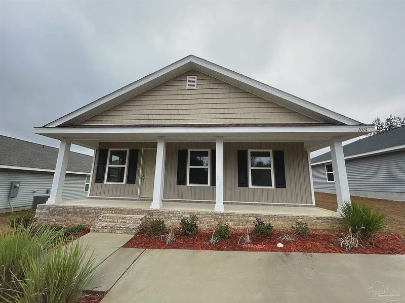 Front exterior of a new home in Turtle Creek, Cantonment, FL, highlighting curb appeal (Image 1). Front exterior of a new home in Turtle Creek, Cantonment, FL, highlighting curb appeal (Image 1).