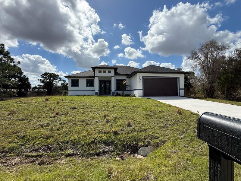 Front exterior of a new home in , Lehigh Acres, FL, highlighting curb appeal (Image 13).