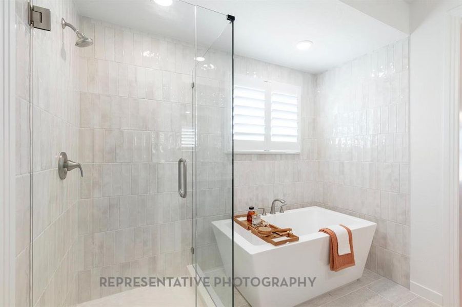 Bathroom featuring a stall shower, a soaking tub, tile walls, tile patterned floors, and recessed lighting