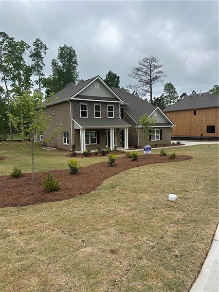 Front exterior of a new home in Mirror Lake at South Harbour, Villa Rica, GA, highlighting curb appeal (Image 21).