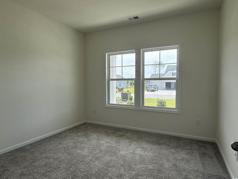 Hallway with wood finished floors and baseboards Hallway with wood finished floors and baseboards