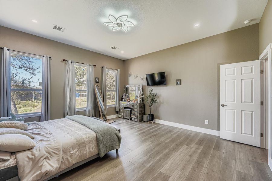 Bedroom with light wood-style flooring and recessed lighting Bedroom with light wood-style flooring and recessed lighting