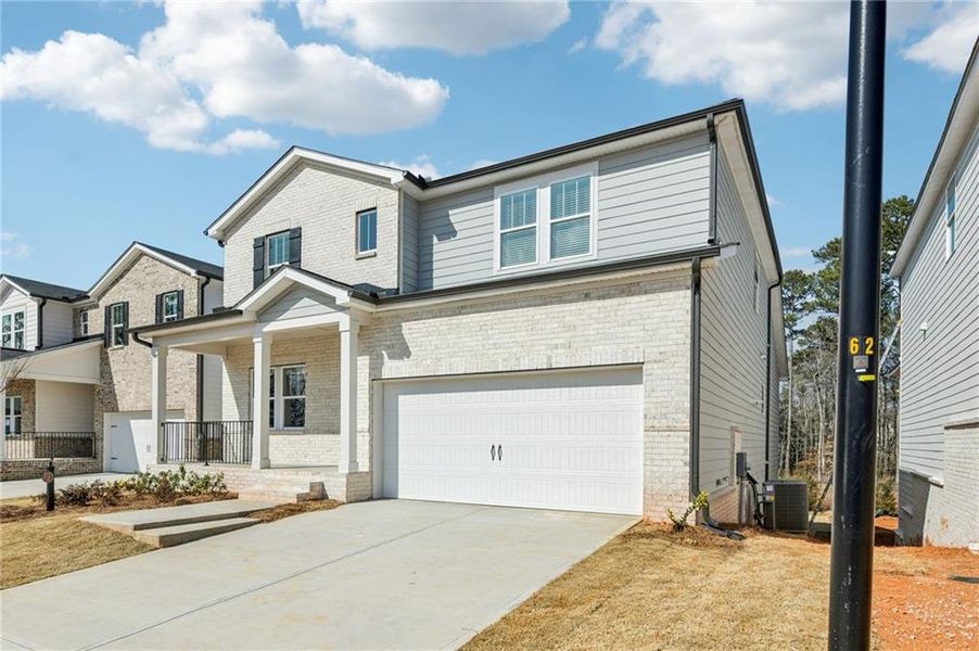 Front exterior of a new home in Martin Springs - Estate Series, Lawrenceville, GA, highlighting curb appeal (Image 2). Front exterior of a new home in Martin Springs - Estate Series, Lawrenceville, GA, highlighting curb appeal (Image 2).