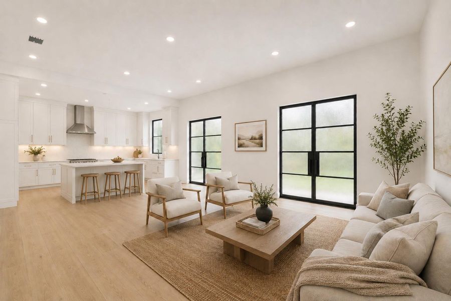 Open-concept living area with light wood-finish flooring
