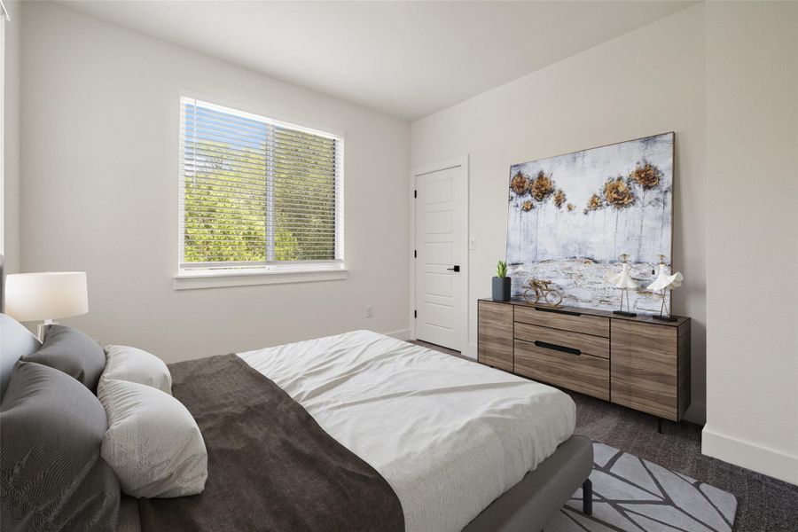 Bedroom with dark colored carpet and baseboards Bedroom with dark colored carpet and baseboards