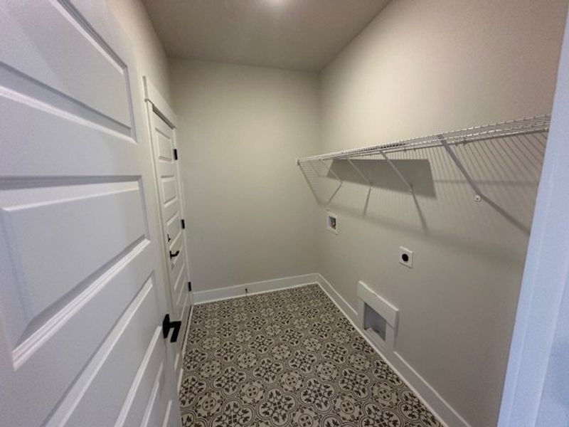 This functional laundry area features elegant patt