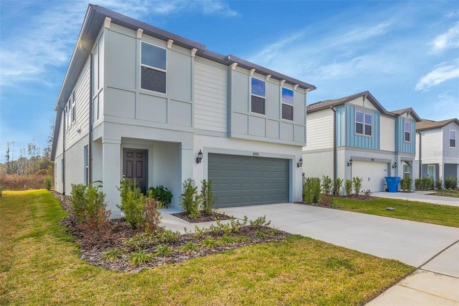 Front exterior of a new home in , Zephyrhills, FL, highlighting curb appeal (Image 23).