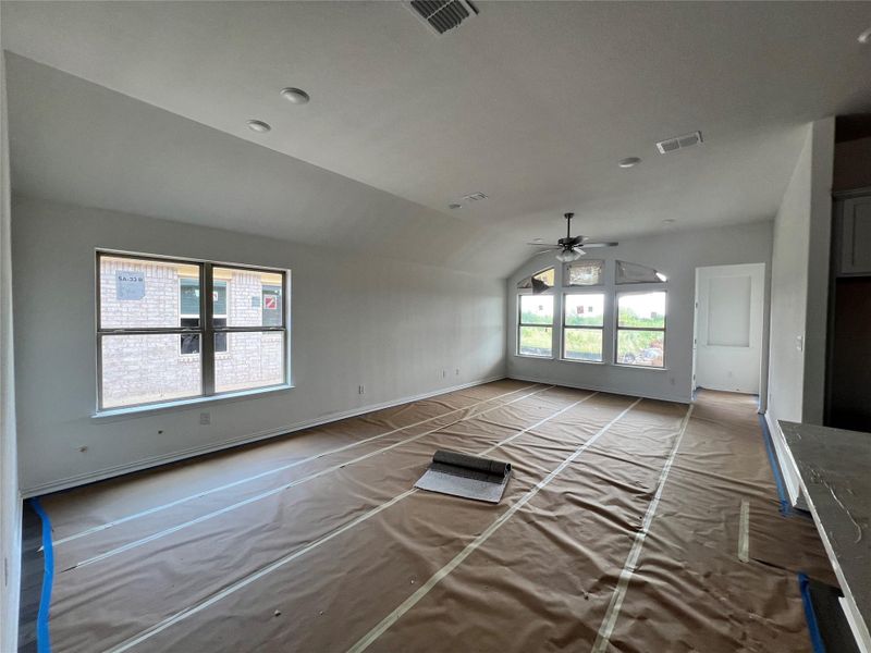Unfurnished living room with vaulted ceiling and ceiling fan Unfurnished living room with vaulted ceiling and ceiling fan
