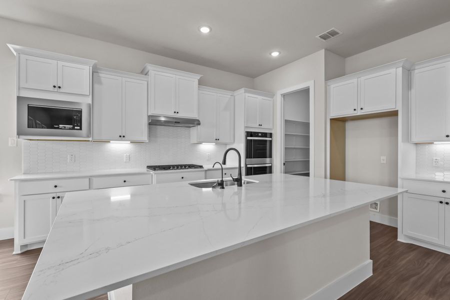 A kitchen with white cabinets. A kitchen with white cabinets.