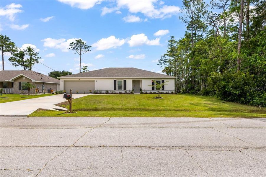 Front exterior of a new home in Palm Coast, Palm Coast, FL, highlighting curb appeal (Image 23). Front exterior of a new home in Palm Coast, Palm Coast, FL, highlighting curb appeal (Image 23).