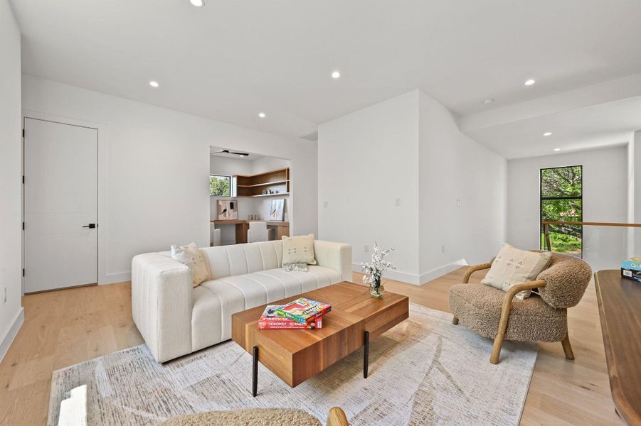 Living room featuring recessed lighting, plenty of natural light, and light wood-style flooring