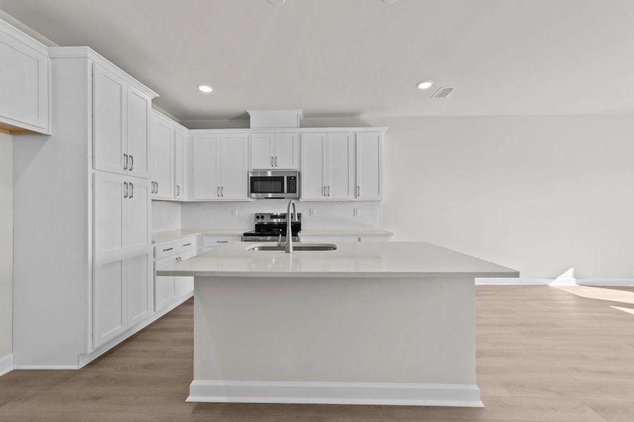 Furnished interior view inside a new home in Blue Heron Retreat: Villas, Little River (Image 8).