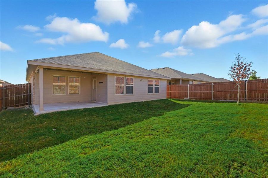 Back of house featuring a patio area, a fenced backyard, and roof with shingles Back of house featuring a patio area, a fenced backyard, and roof with shingles