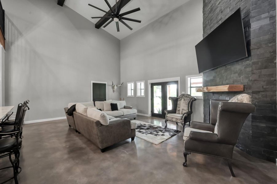 cozy stone fireplace with a mounted TV and adjacent seating.