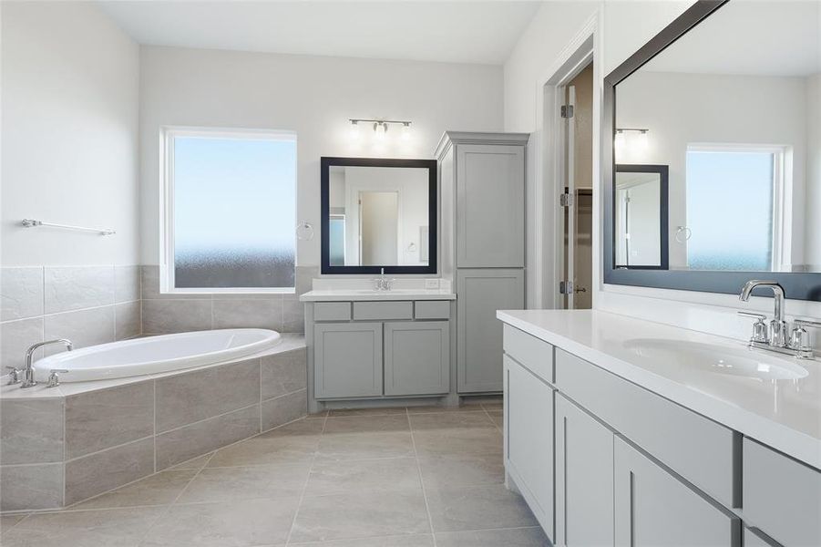 Bathroom with two vanities, a bath, and light tile patterned floors Bathroom with two vanities, a bath, and light tile patterned floors