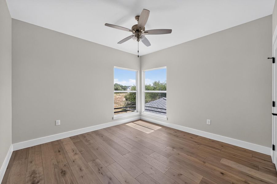 Rich wood plank flooring sets a warm tone in this versatile corner room.