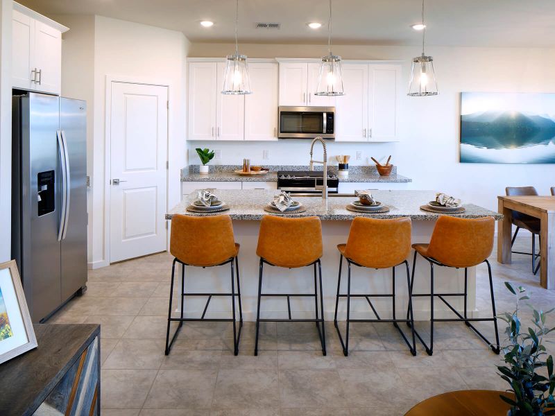 Free flowing kitchen featuring white cabinets and white granite counter tops