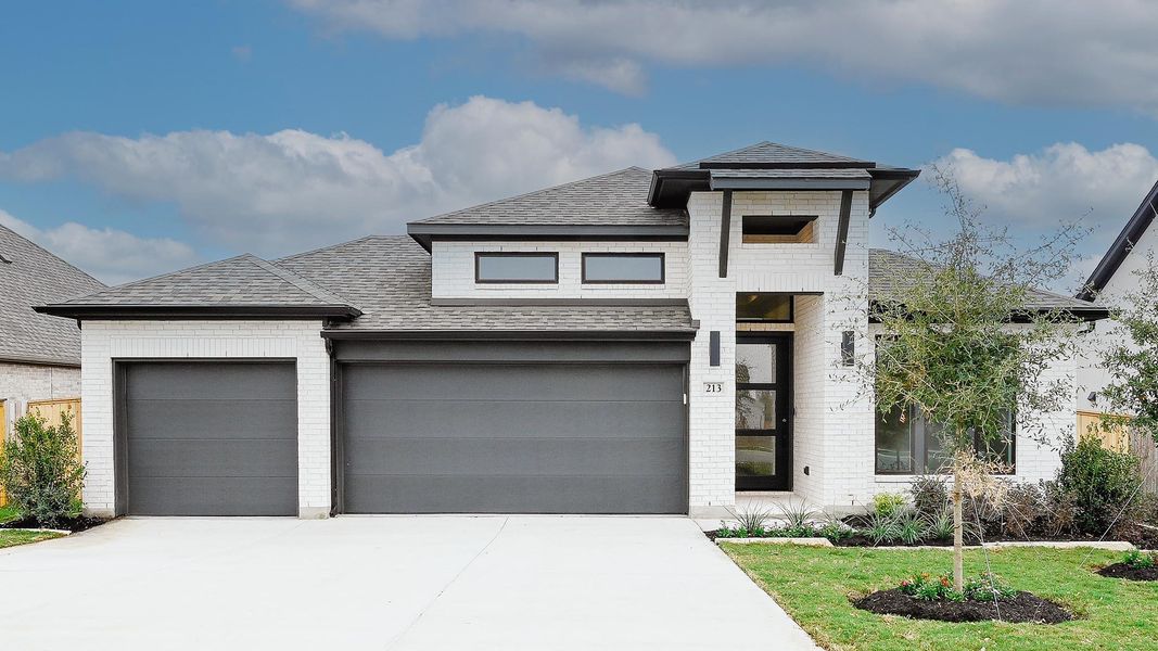 Front exterior of a new home in La Cima 60', San Marcos, TX, highlighting curb appeal (Image 17). Front exterior of a new home in La Cima 60', San Marcos, TX, highlighting curb appeal (Image 17).