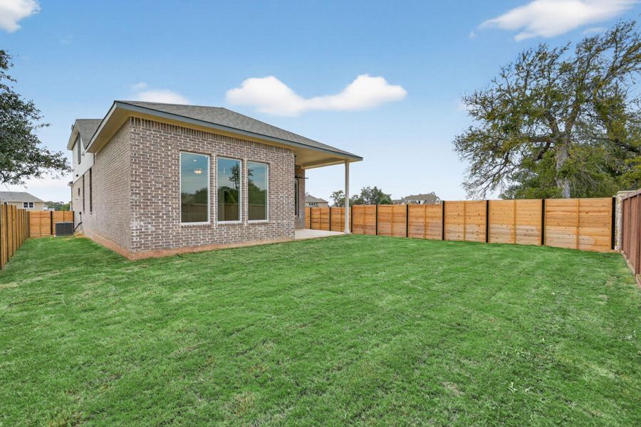 Back of property with a patio, brick siding, and a fenced backyard