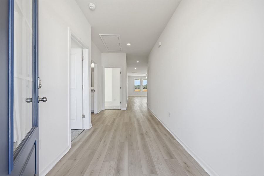 Hall featuring attic access, recessed lighting, and light wood-style flooring