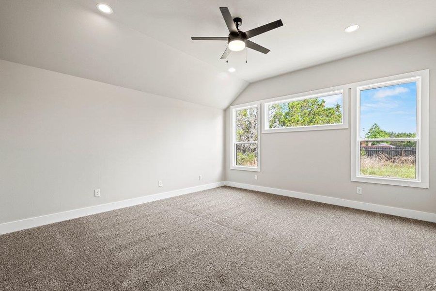 Unfurnished room featuring recessed lighting, baseboards, ceiling fan, carpet flooring, and vaulted ceiling Unfurnished room featuring recessed lighting, baseboards, ceiling fan, carpet flooring, and vaulted ceiling
