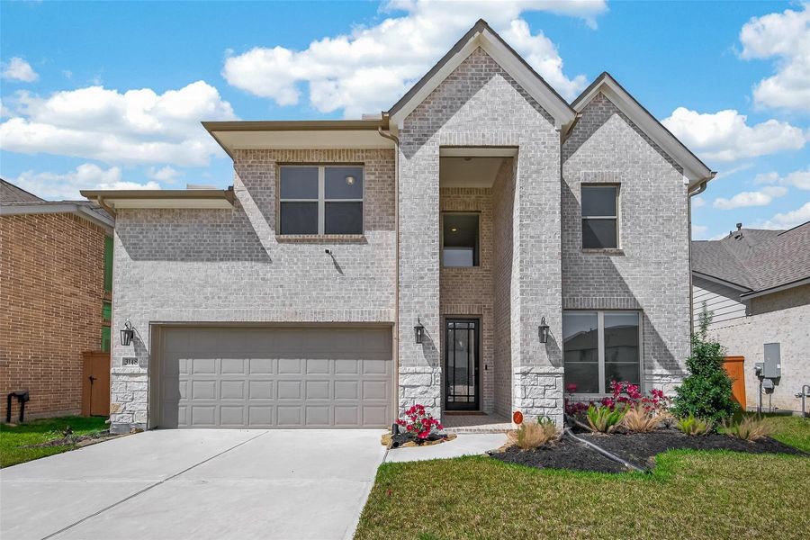 Front exterior of a new home in Sunterra, Katy, TX, highlighting curb appeal (Image 26). Front exterior of a new home in Sunterra, Katy, TX, highlighting curb appeal (Image 26).