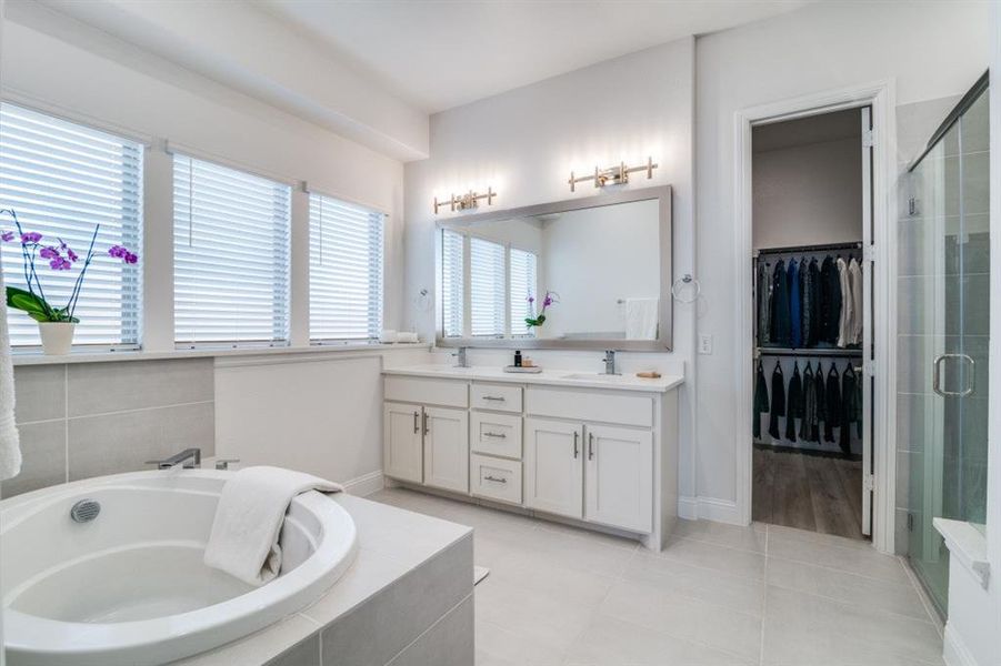 Full bathroom with a sink, a stall shower, a bath, double vanity, and tile patterned flooring Full bathroom with a sink, a stall shower, a bath, double vanity, and tile patterned flooring