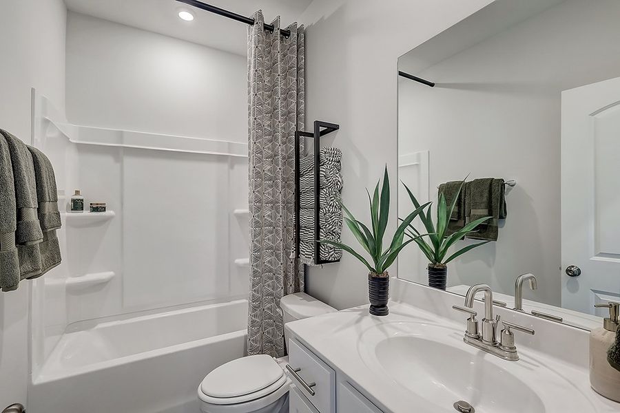 A bathroom with a sink and a shower.