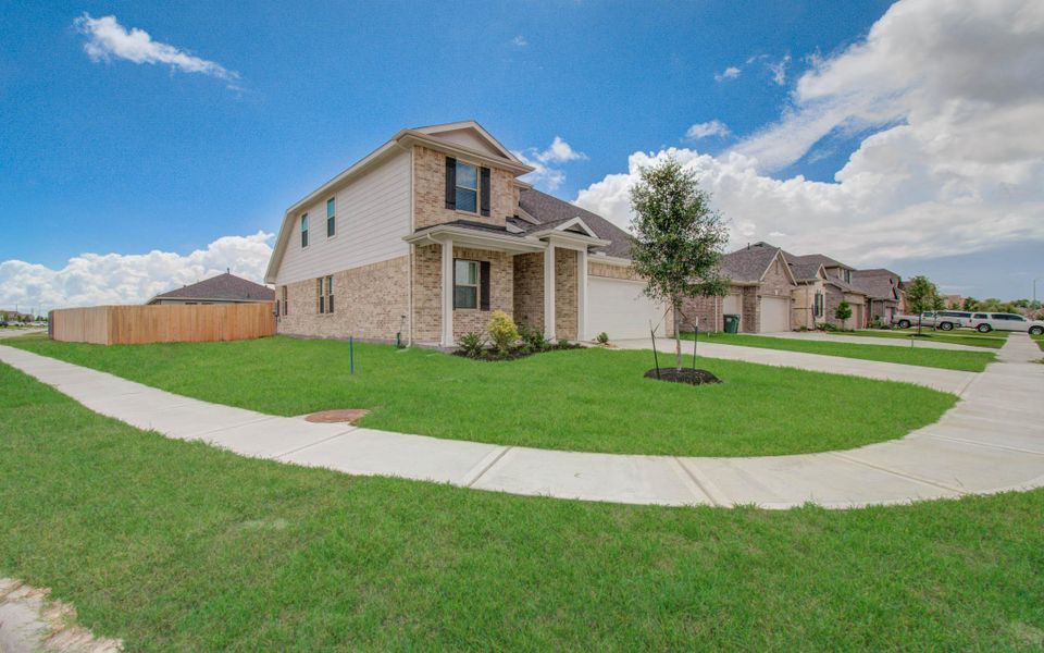 Front exterior of a new home in Legends Bay, Baytown, TX, highlighting curb appeal (Image 21).
